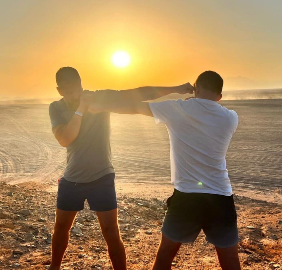 Two people training together outdoors